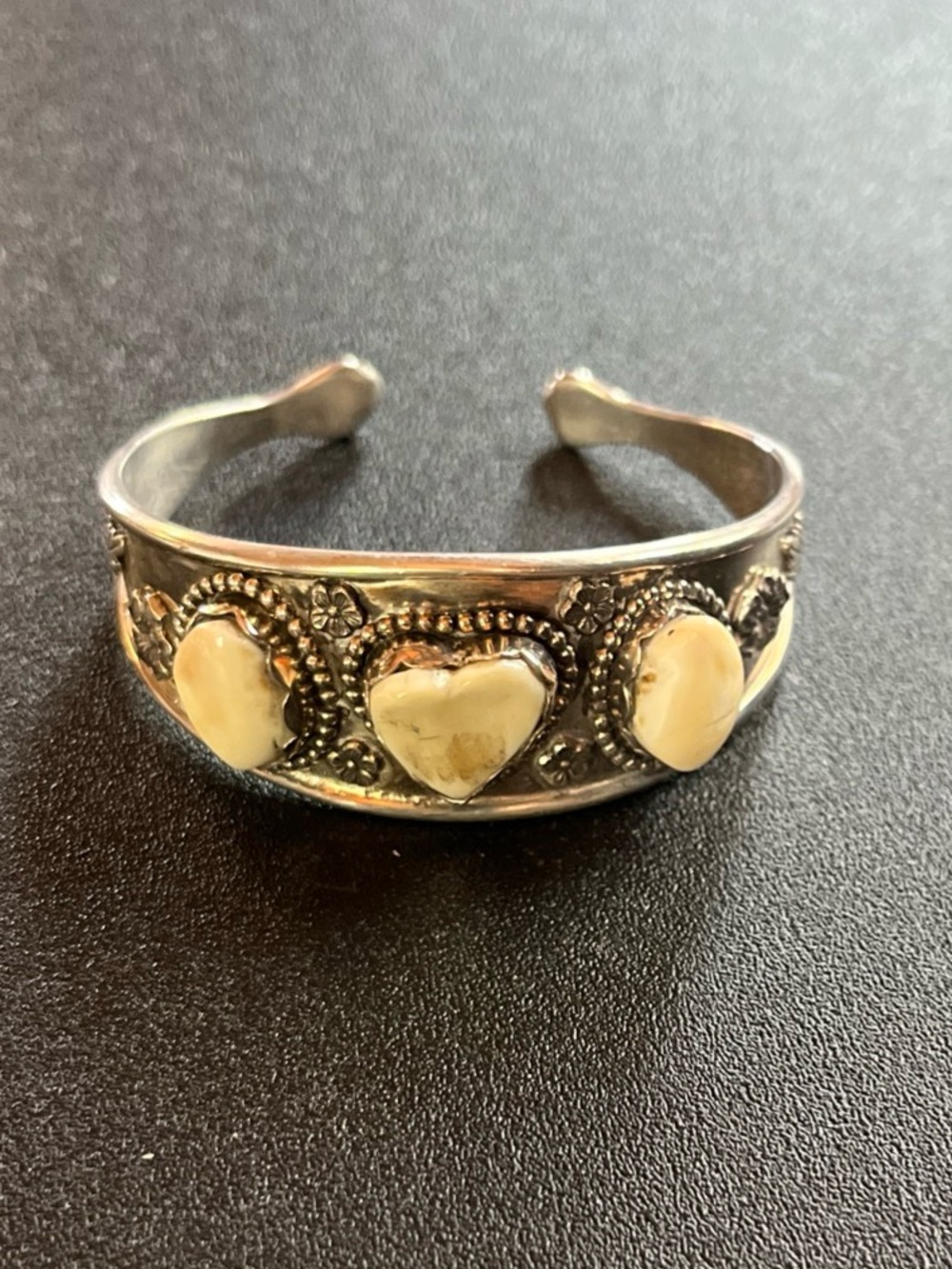 Sterling silver cuff with elks teeth. Heart shaped. Good detail. 6” inner. 31gr